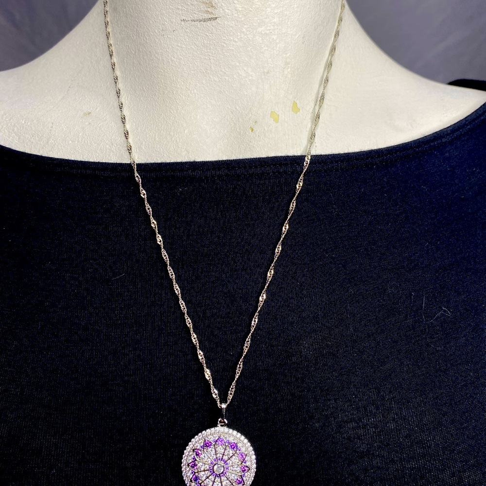 Silver plated cubic zirconia necklace with geometric pendant.